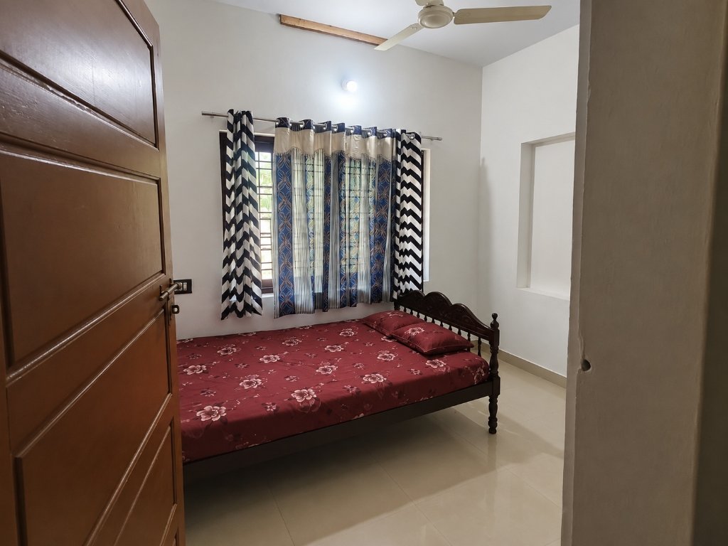 Clean and comfortable private bedroom at Niraamayam